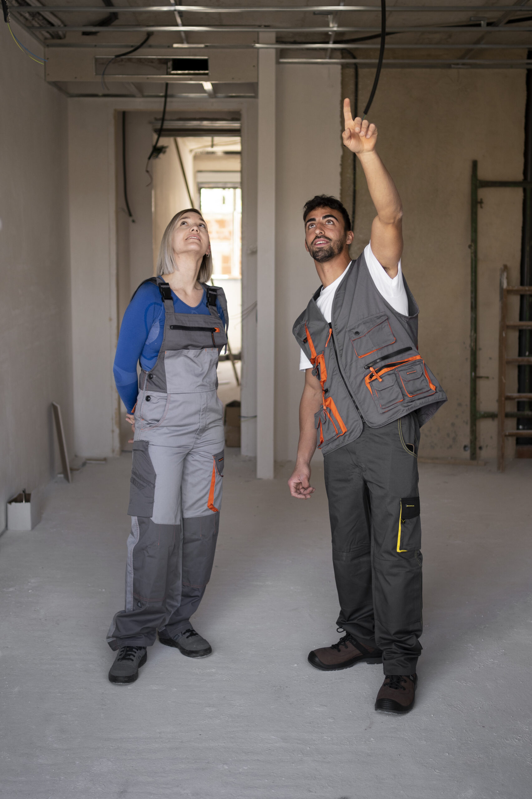 full-shot-smiley-construction-workers-job-scaled.jpg